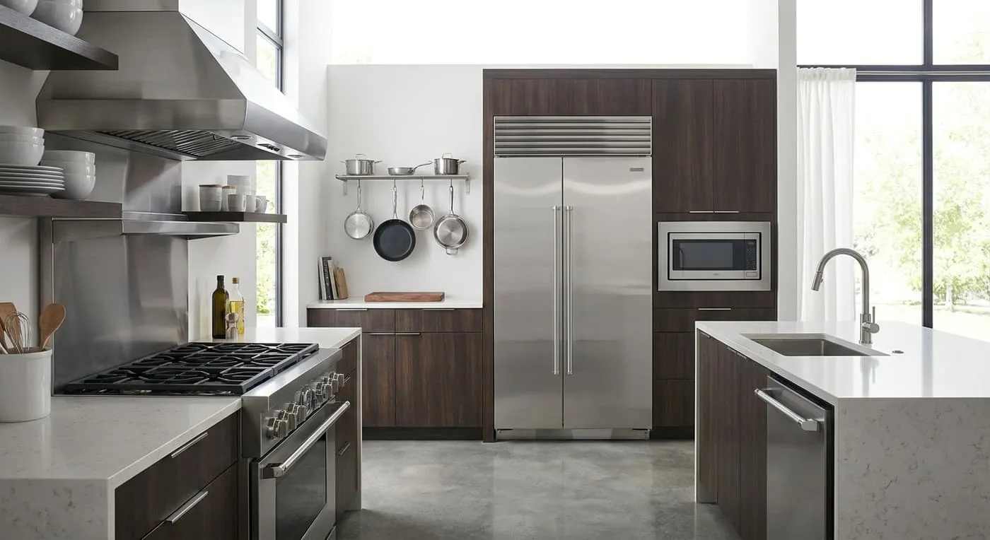 A modern kitchen with a stainless steel fridge, stove, dishwasher and microwave